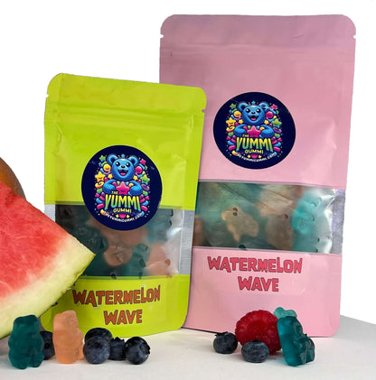 Yummi Gummi Watermelon Wave packs with watermelon slices and gummy bears, featuring pink grapefruit, blue raspberry, and watermelon flavors.